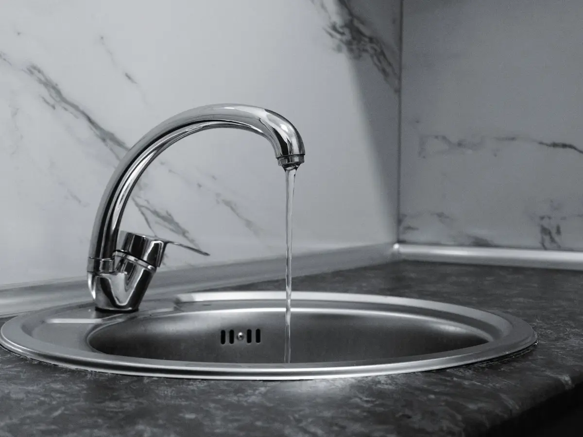 Example: new chrome faucet running over a sink